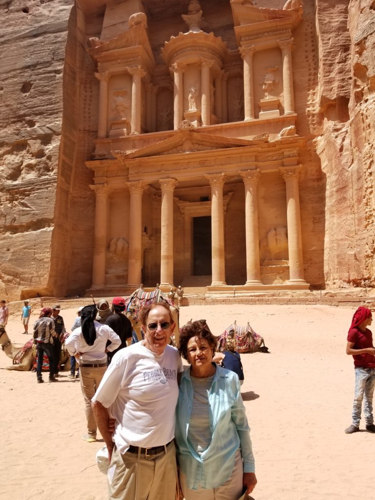 Couple standing in front of the Petra ruins