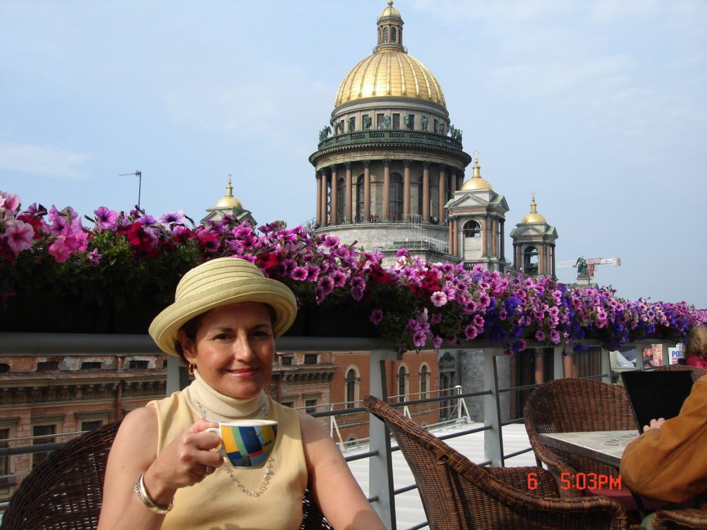 Woman drinking tea with St. Isaac's Cathedral in the background