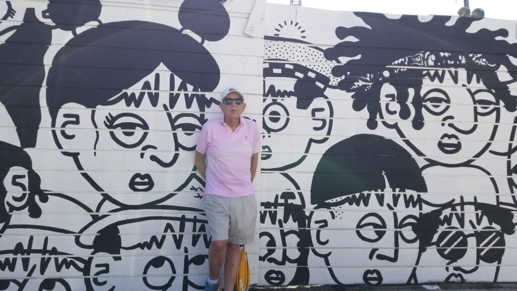 Steve is in front of the colorful mural walls of Wynwood in Miami.