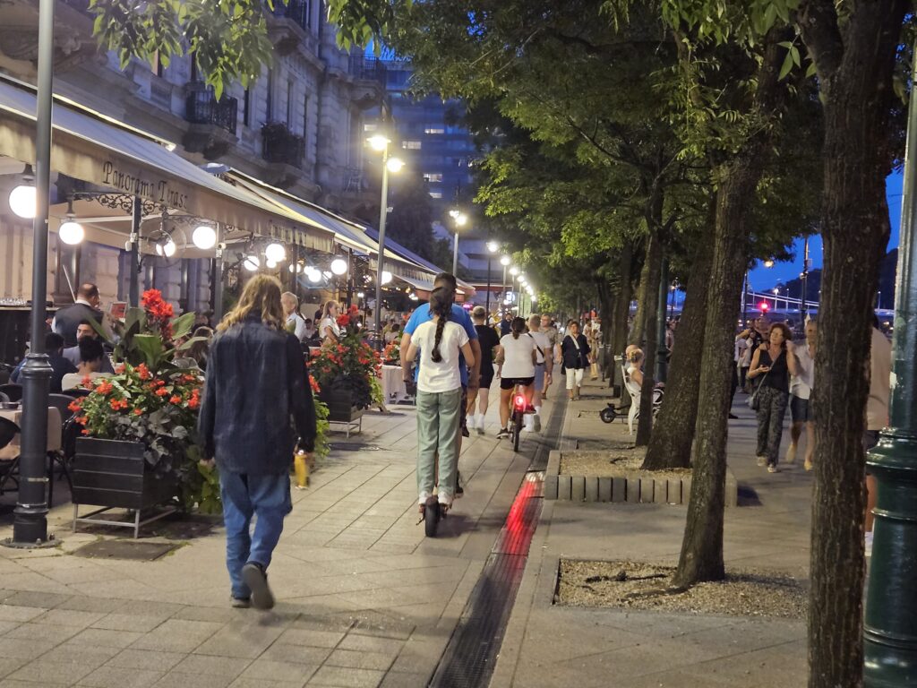 Pedestrians enjoying a summer nighttime stroll on the Promenade along the Danube in Budapest, Hungary